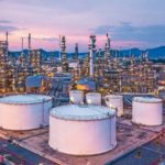 Aerial_top_view_oil_and_gas_chemical_tank_with_oil_refinery_plant_background_at_twilight.